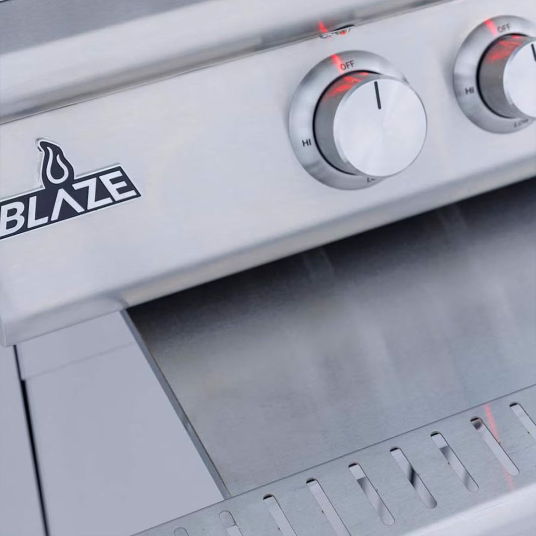 Close-up of a Blaze grill with control knobs and logo.